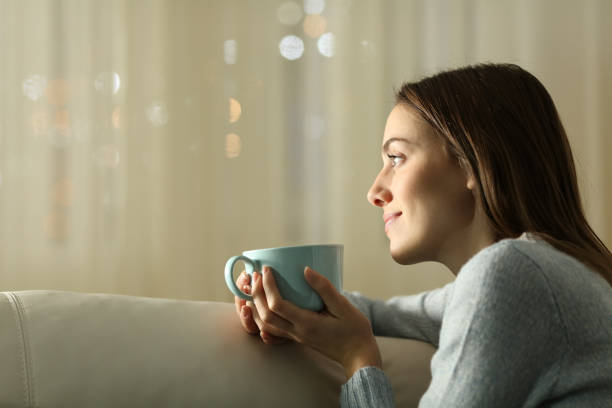 istock Woman thinking and drinking coffee in the night at home 2200802841
