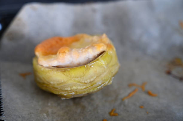 istock Delightful pastry filled with savory ingredients, resting on parchment paper in a warm kitchen 2200803462