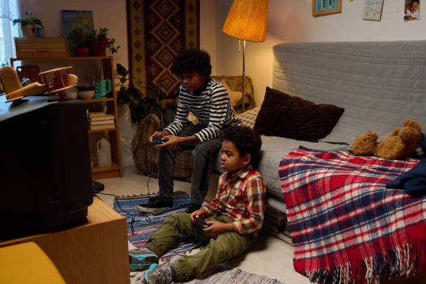 istock Kids Playing Video Games in Cozy Living Room Setting 2200803804