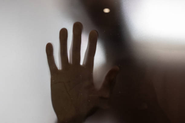 istock Diffused male hand behind frosted glass 2200804246