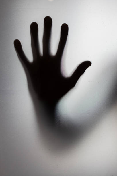 istock Diffused male hand behind frosted glass 2200804253