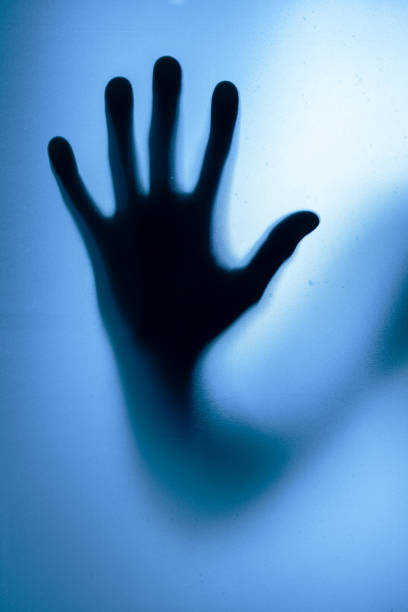 istock Diffused male hand behind frosted glass 2200804281
