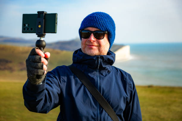 istock Man vlogging and creating content at Seven Sisters cliffs in East Sussex, UK 2200805593