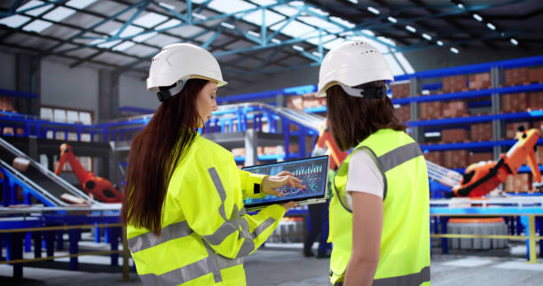 istock Female Warehouse Inspector Ensures OSHA Compliance Through Automation 2200808257