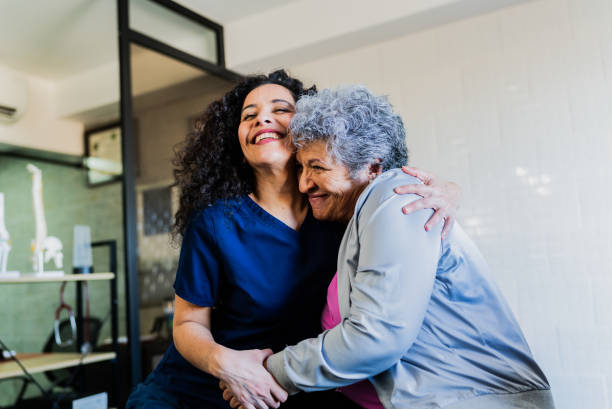 istock Physical Therapist talking and embracing senior patient 2200808733