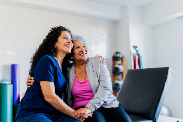 istock Physical Therapist embracing senior patient 2200809077