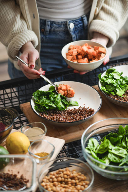 istock Female Creating Aesthetically Pleasing Buddha Bowls With Colorful Nutritious Ingredients 2200814156