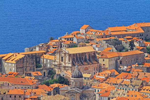 Dubrovnik, Croatia - April 19, 2011: Aerial View of Roman Catholic Cathedral Dome and Orthodox Church of Holy Annucination in Old Town Christianity Religion Landmarks at Sunny Spring Day.