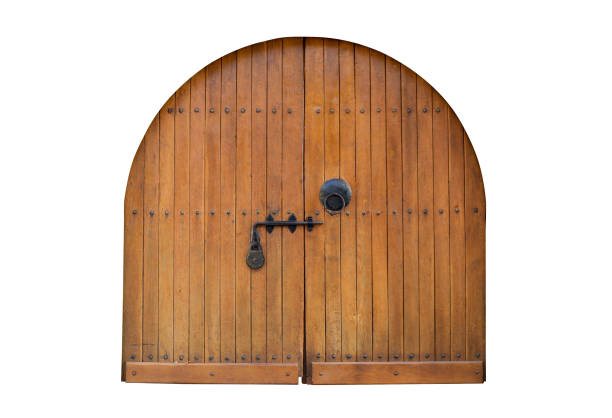 istock Arched wooden doors viewed from the inside, featuring a locking bar and a secured padlock, evoking a rustic and historic atmosphere 2200816172