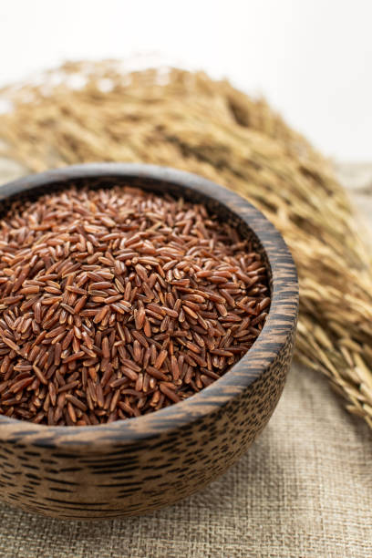 istock unhulled asian red rice grains in rustic setting display in Cambodia 2200819970