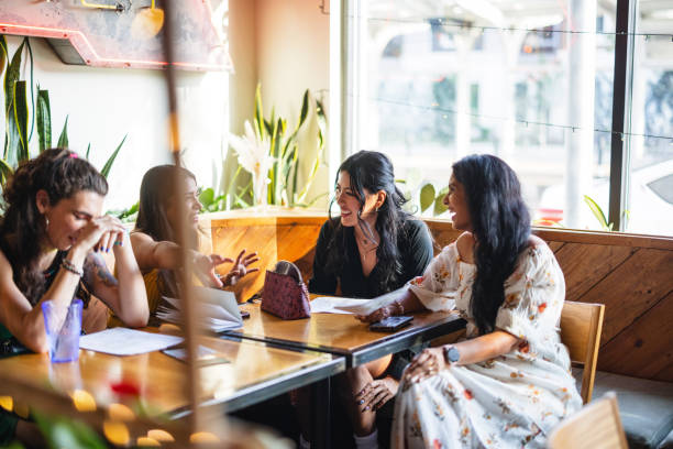 istock Diverse Group of Students Studying in Cozy Bar 2200821388