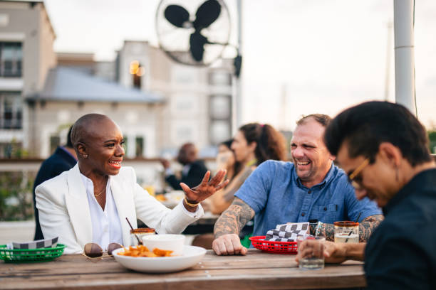 istock Cheerful Bald Black Woman Enjoying Rooftop Socializing 2200821436