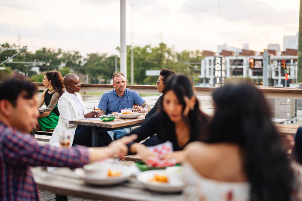 istock Diverse Friends Enjoying Dining on Rooftop Bar 2200821459