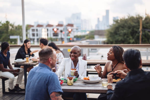 istock Diverse Friends Laughing at Rooftop Bar Gathering 2200821469