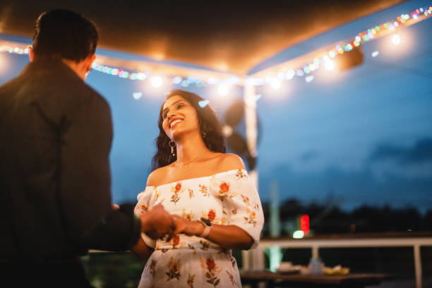istock Joyful Hispanic and Indian Couple Dancing at Rooftop Party 2200821499