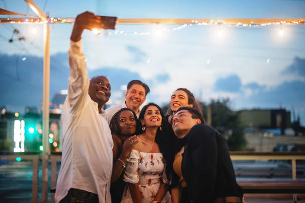 istock Diverse Group Enjoying Happy Rooftop Evening Selfie 2200821505