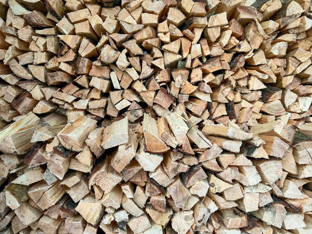 istock Firewood, pine, cut, split and stacked to dry, close-up as background 2200821518