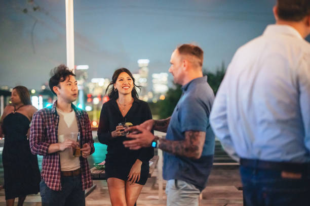 istock Cheerful Diverse Friends Gather at Rooftop Party 2200821539