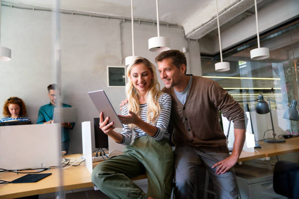 istock Working together on project. Two young business colleagues working together in startup office 2200824824
