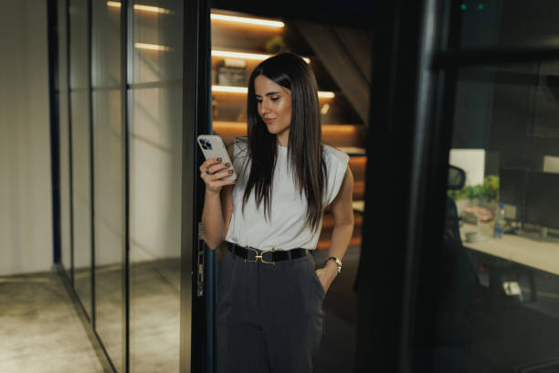 istock Businesswoman Using Smart Phone in Trendy Workspace 2200824829