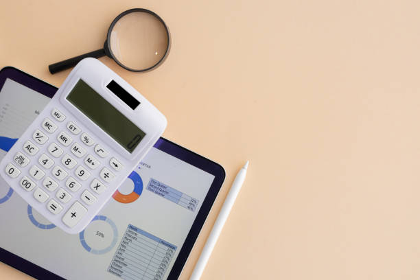 istock close up top view on calculator with magnify glass and digital tablet and summary graph and chart screen dashboard about business's data for report monthly management of b2b financial and economy concept 2200828172