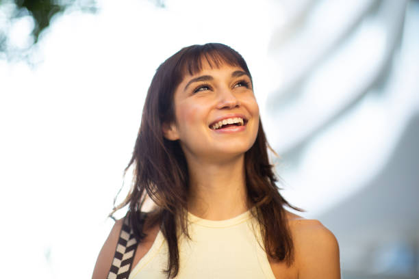 istock Happy young woman standing outside 2200828396