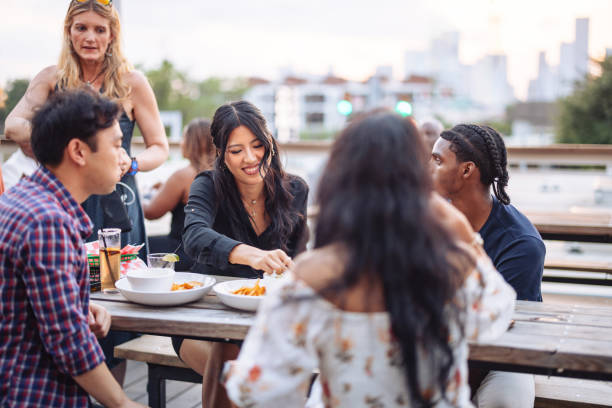 istock Diverse Friends Enjoying Rooftop Meal Together 2200828408