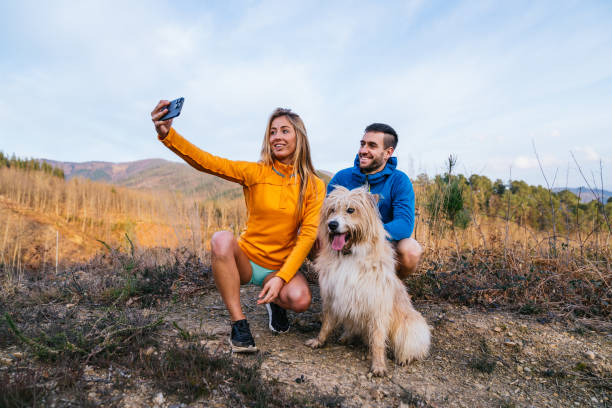 istock Hikers taking a selfie with their dog in the mountains 2200830756