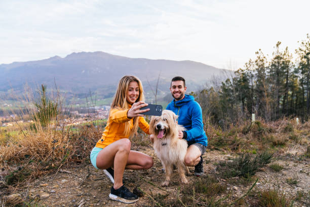 istock Hikers taking a selfie with their dog in the mountains 2200830767