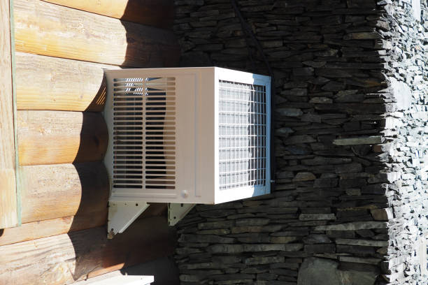 istock Air conditioning unit attached to a rustic stone and wood exterior on a sunny day. 2200832693
