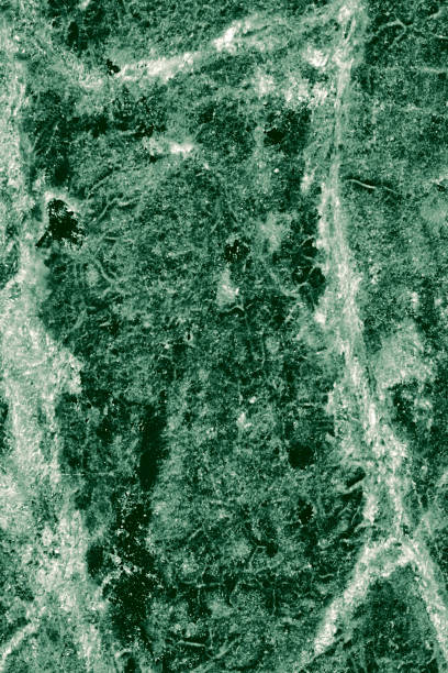 Real closeup of dark green marble stone texture surface background. Design pattern with high resolution for luxury home decoration. Abstract matt slab rock material. Front view of natural tiles stone surface.