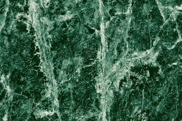 istock Real closeup of dark green marble stone texture surface background. Design pattern with high resolution for luxury home decoration. Abstract matt slab rock material. Front view of natural tiles stone surface. 2200833145