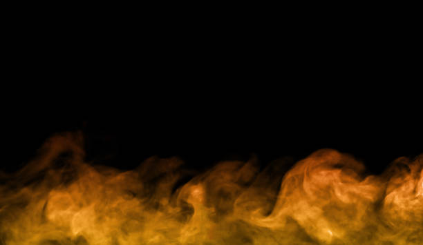 Orange smoke effect floating on black background. Abstract bright and intense background. Fog or smoke.