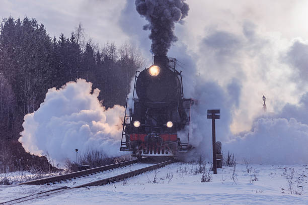 istock Retro steam train moves at winter morning. 2200836039