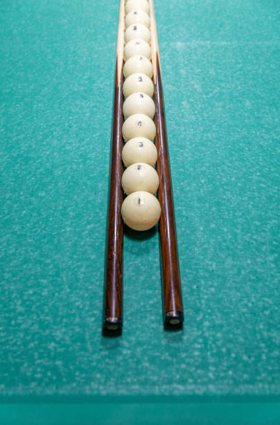 Snooker Pool balls arrange in row and cue on table.