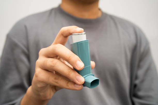 istock Asthma and chronic obstructive pulmonary disease COPD, Asian young man using metered dose inhaler MDI. 2200843285