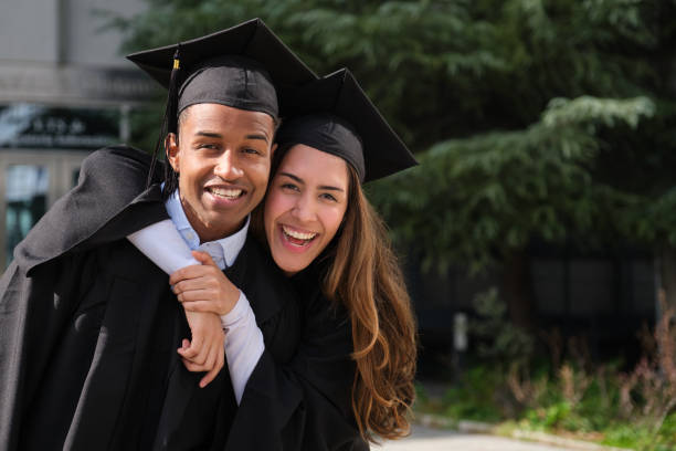 istock Two happy students embracing each other on graduation day 2200843945