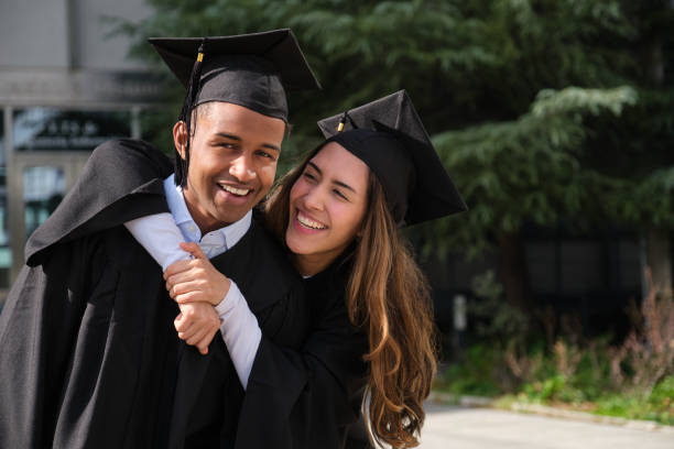 istock Two happy students celebrating their graduation day 2200844076