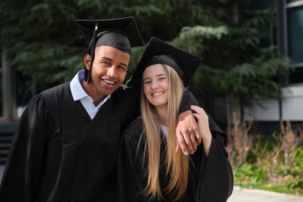 istock Two happy students celebrating their graduation day 2200844214