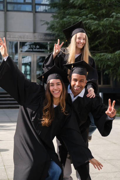 istock Happy graduated students celebrating their graduation day 2200845105