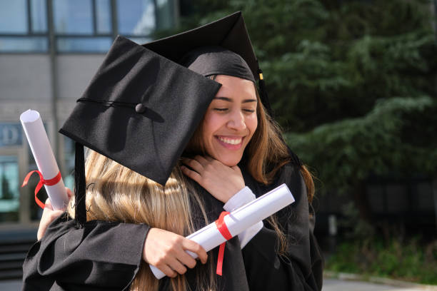 istock Two happy students hugging and celebrating graduation day 2200847574