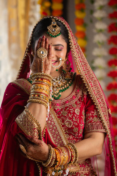 Shy bride with eyes closed hiding her face with hand