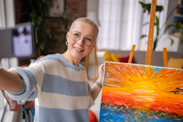 Young artist captures joyful moment in her cozy home studio while painting a vibrant sunset