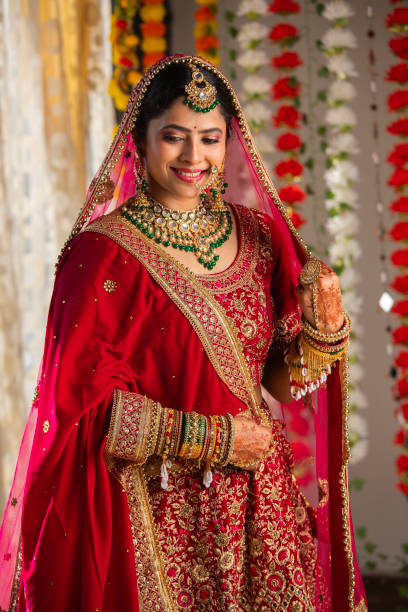 istock Bride with dupatta on head looking down in wedding ceremony 2200850333