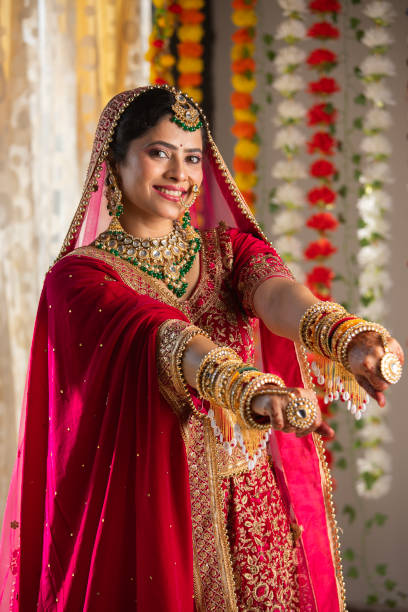 istock Smiling bride in wedding dress showing her bangles 2200850605