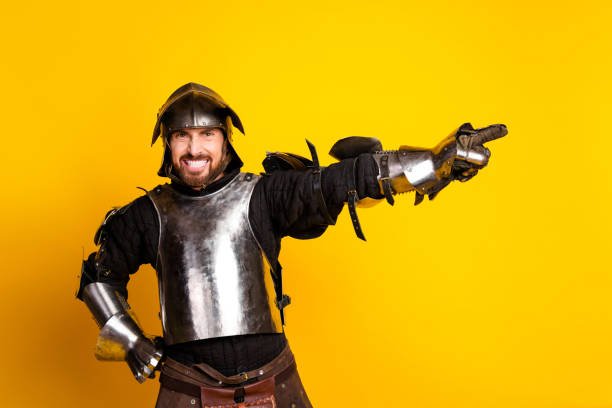 istock Medieval knight in full armor with a vibrant yellow background and an expressive pose 2200850785