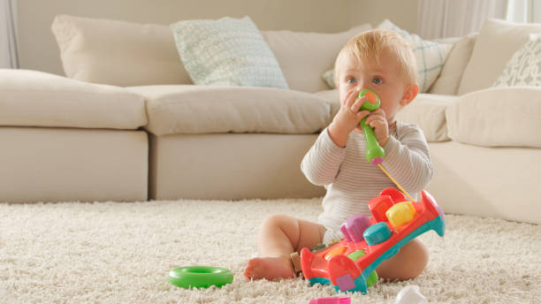 istock Young Boy Playing With Toy Xylophone At Home 2200850969
