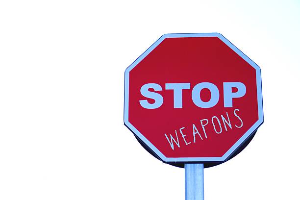 istock stop weapons. roadside stop sign with written words 2200851377