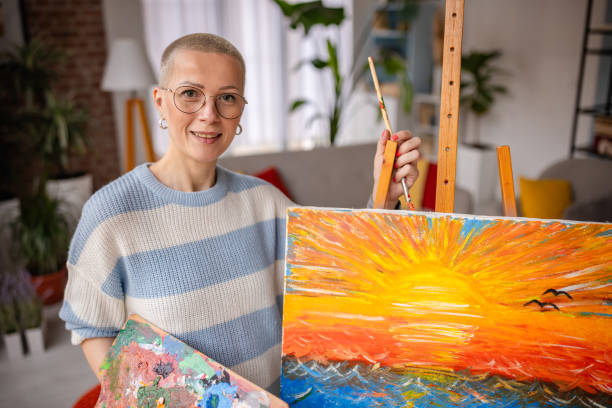 istock Young artist joyfully painting in her cozy home studio during a relaxing weekend 2200852314