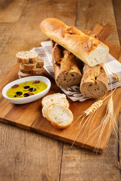 istock French Baguettes on a Cutting Board with Olive Oil 2200852379